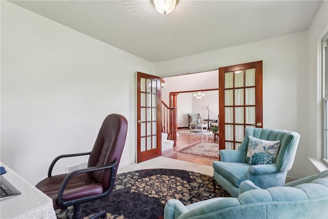 office with french doors, wood finished floors, and a chandelier