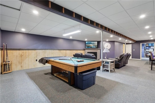 game room with carpet, a paneled ceiling, pool table, a wainscoted wall, and wooden walls