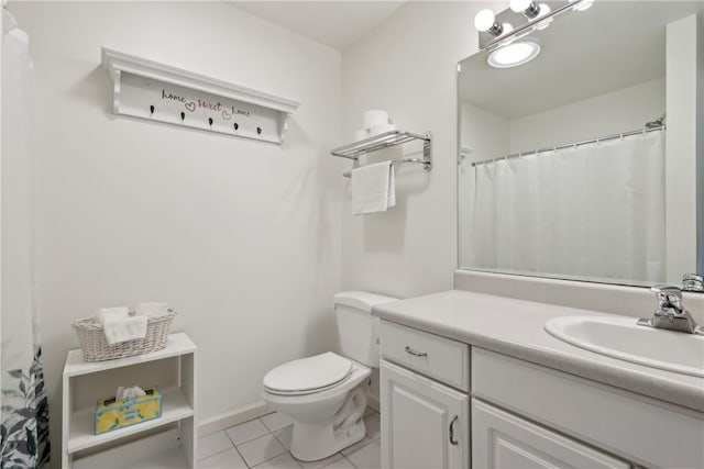 full bath featuring tile patterned floors, toilet, vanity, and baseboards