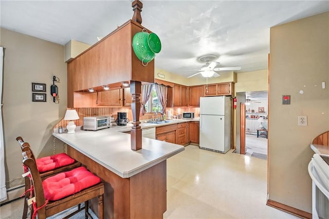1807 Memorial, Farrell, PA 16121 - kitchen with white appliances, a sink, light countertops, a ceiling fan, and a peninsula