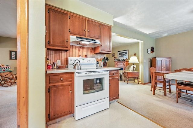 1807 Memorial, Farrell, PA 16121 - kitchen with white electric range oven, under cabinet range hood, light colored carpet, and light countertops