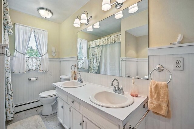 1807 Memorial, Farrell, PA 16121 - full bath featuring a baseboard radiator, wainscoting, toilet, double vanity, and tile patterned floors