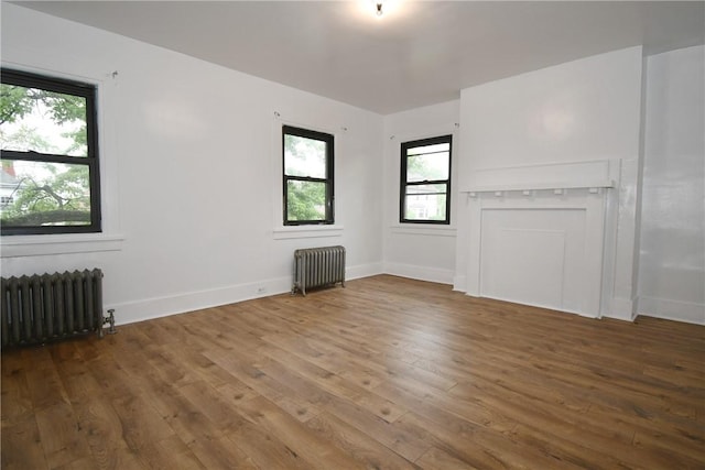 21 Hillson Ave, Brentwood, PA 15227 - unfurnished living room featuring radiator heating unit, hardwood / wood-style flooring, and plenty of natural light