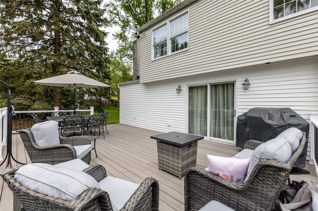 wooden deck featuring outdoor dining space and grilling area