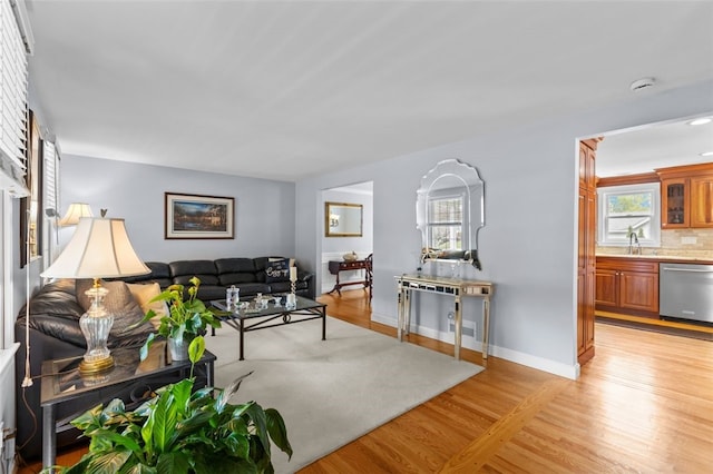 living room featuring light wood finished floors and baseboards