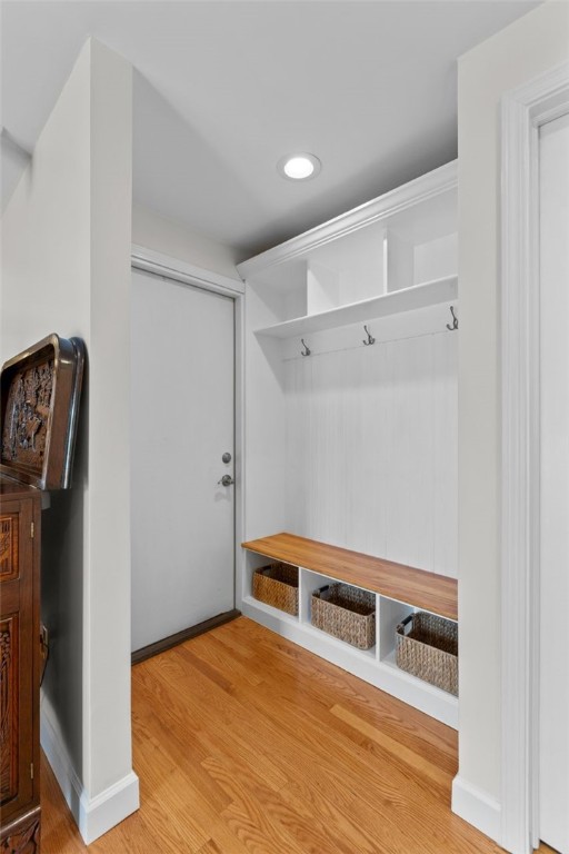 mudroom with light wood finished floors, baseboards, and recessed lighting
