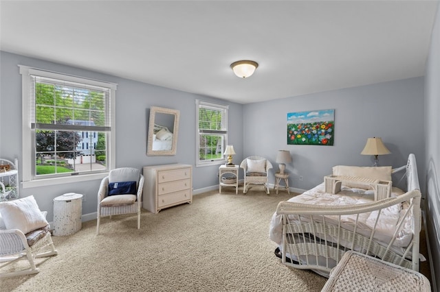 carpeted bedroom with multiple windows and baseboards