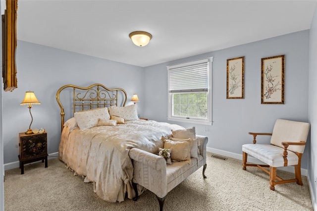 bedroom with baseboards and light carpet