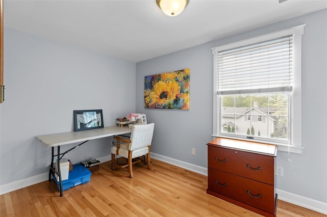 office space featuring light wood-type flooring and baseboards