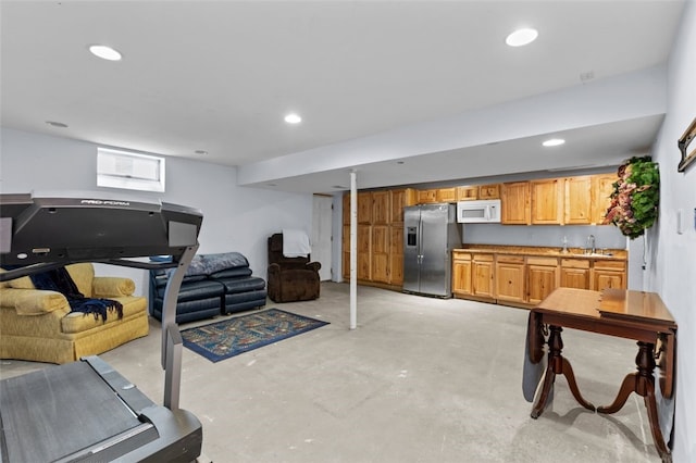 exercise area featuring recessed lighting and a sink