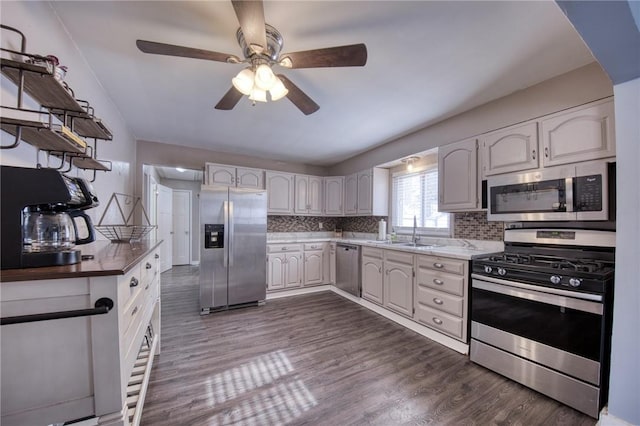 5 Jackson St, Kennedy Twp, PA 15108 - kitchen with appliances with stainless steel finishes, a sink, decorative backsplash, a ceiling fan, and dark wood-style flooring