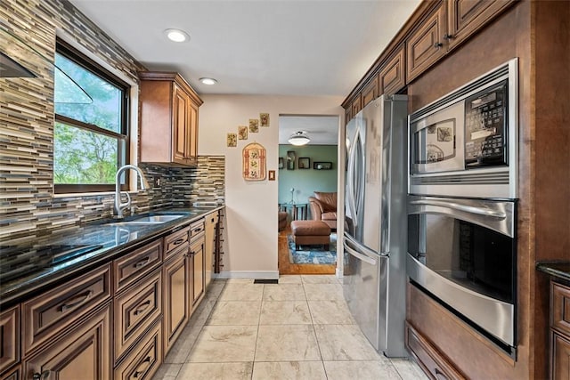 2880 Willowick Ct, South Fayette, PA 15017 - kitchen with appliances with stainless steel finishes, a sink, backsplash, dark stone counters, and recessed lighting