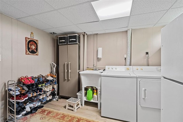 2880 Willowick Ct, South Fayette, PA 15017 - washroom featuring washing machine and clothes dryer, light wood-style flooring, and a decorative wall