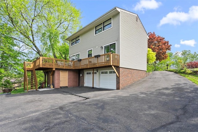 2880 Willowick Ct, South Fayette, PA 15017 - rear view of house with stairway, a deck, asphalt driveway, an attached garage, and brick siding