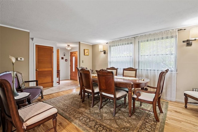 2880 Willowick Ct, South Fayette, PA 15017 - dining space with light wood-style flooring and crown molding