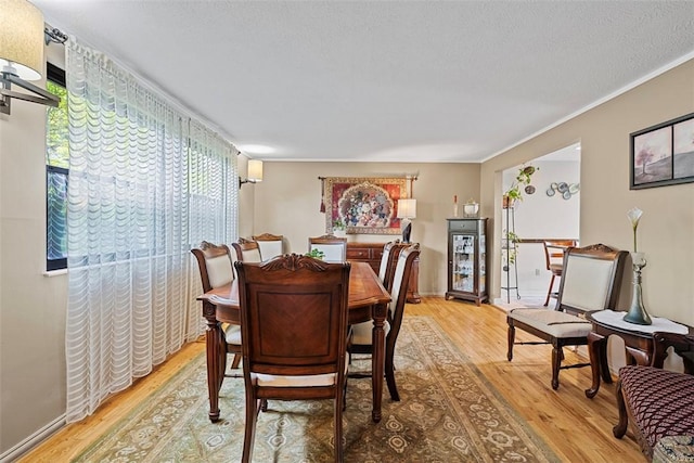 2880 Willowick Ct, South Fayette, PA 15017 - dining room with light wood-style flooring and a textured ceiling