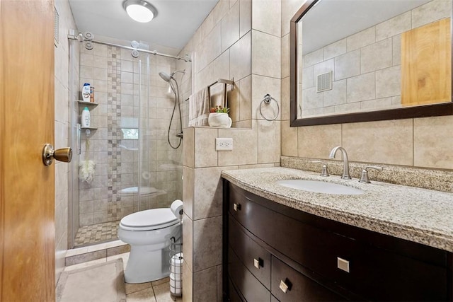 2880 Willowick Ct, South Fayette, PA 15017 - bathroom with tile walls, a shower stall, toilet, vanity, and tile patterned flooring
