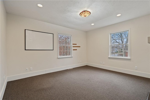 396 4th St, Beaver, PA 15009 - empty room featuring dark carpet, a textured ceiling, recessed lighting, and baseboards