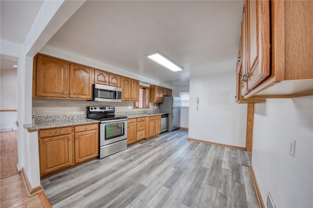 433 Brunner Dr, Monroeville, PA 15146 - kitchen featuring appliances with stainless steel finishes, baseboards, and light wood-type flooring