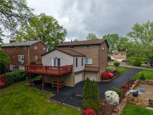 433 Brunner Dr, Monroeville, PA 15146 - back of property with a deck, an attached garage, a lawn, and driveway