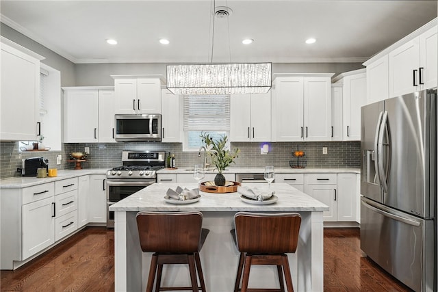 608 N Euclid Ave, East Liberty, PA 15206 - kitchen with appliances with stainless steel finishes, ornamental molding, a breakfast bar, white cabinets, and recessed lighting