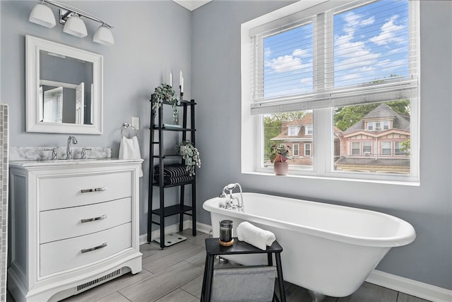 608 N Euclid Ave, East Liberty, PA 15206 - bathroom with baseboards, a freestanding bath, and vanity