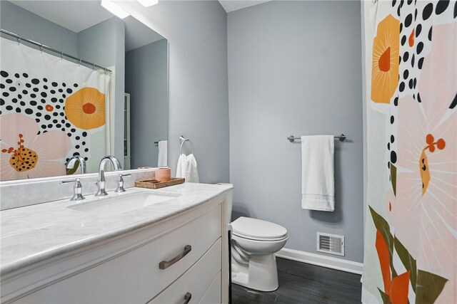 608 N Euclid Ave, East Liberty, PA 15206 - bathroom with baseboards, vanity, toilet, and wood finished floors