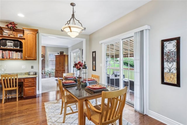 dining room with light wood-style flooring, baseboards, and recessed lighting