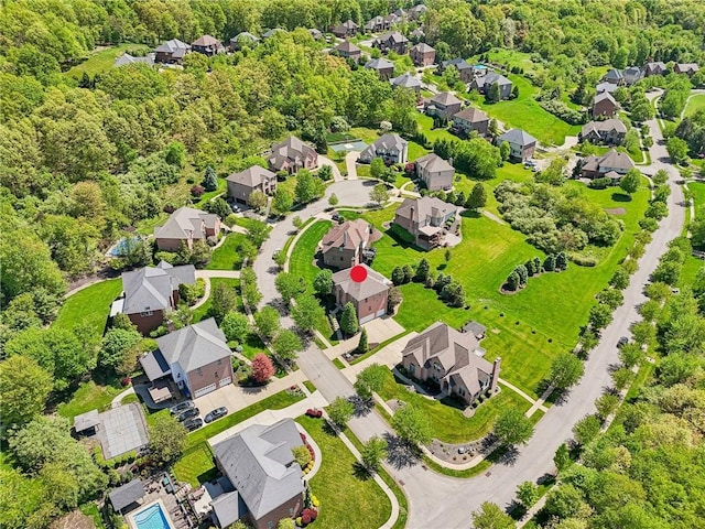 aerial perspective of suburban area featuring a forest
