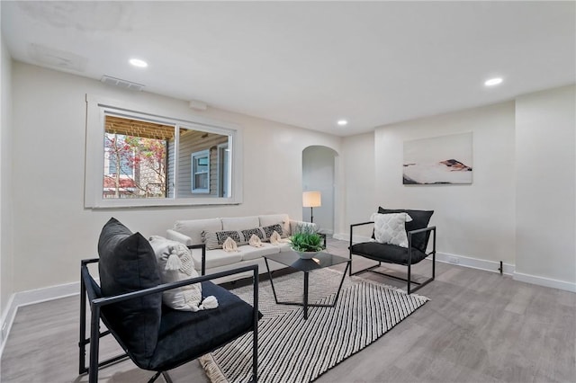 3423 Denny St, Lawrenceville, PA 15201 - living room featuring arched walkways, wood finished floors, baseboards, and recessed lighting