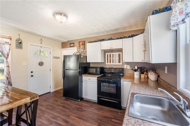 kitchen featuring black appliances, a sink, white cabinetry, dark wood finished floors, and light countertops