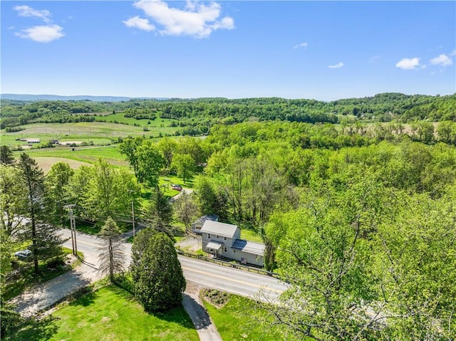 view of subject property featuring a heavily wooded area