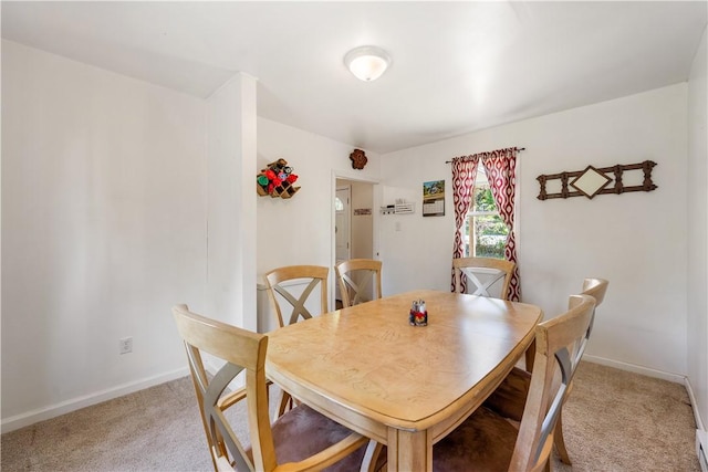dining room with light carpet and baseboards