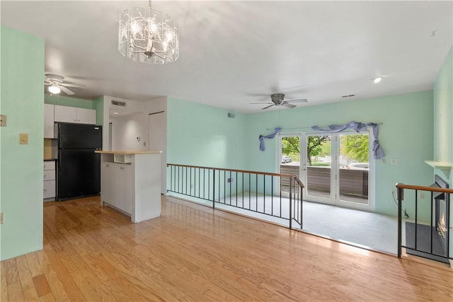 2409 Kenzie Dr, Robinson Twp Nwa, PA 15205 - unfurnished living room with a ceiling fan, light wood finished floors, and a chandelier