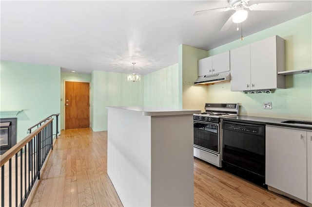 2409 Kenzie Dr, Robinson Twp Nwa, PA 15205 - kitchen with gas range oven, black dishwasher, extractor fan, a chandelier, and light wood finished floors
