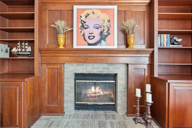 detailed view of built in shelves and a fireplace