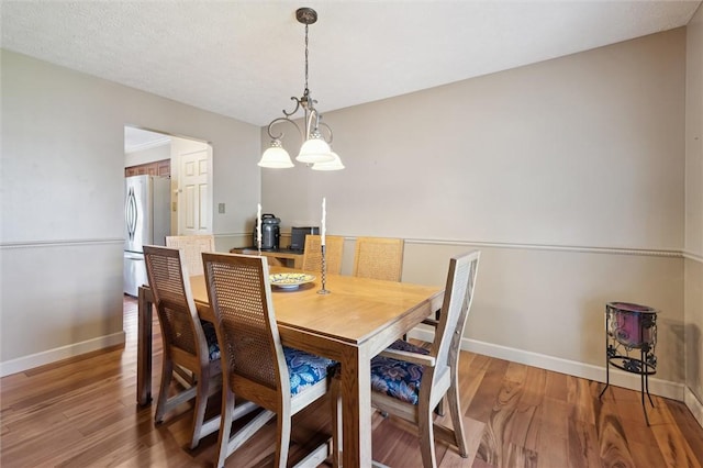 dining area with light wood finished floors and baseboards