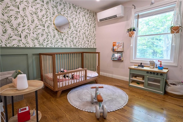 605 E Portersville Rd, Muddy Creek Twp, PA 16051 - bedroom with wallpapered walls, an AC wall unit, multiple windows, wood finished floors, and a wainscoted wall