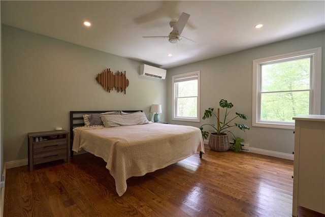 605 E Portersville Rd, Muddy Creek Twp, PA 16051 - bedroom featuring an AC wall unit, multiple windows, wood finished floors, and recessed lighting