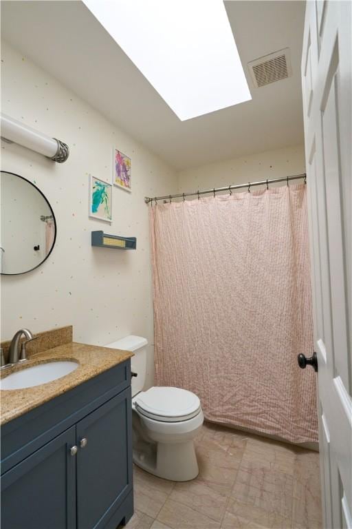 605 E Portersville Rd, Muddy Creek Twp, PA 16051 - bathroom featuring vanity, toilet, and a skylight