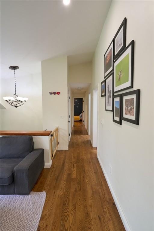 605 E Portersville Rd, Muddy Creek Twp, PA 16051 - hall featuring wood finished floors, baseboards, an upstairs landing, and a chandelier