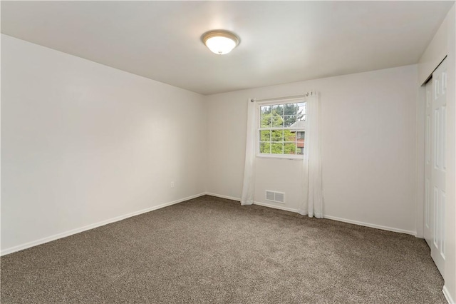 unfurnished room featuring carpet floors and baseboards