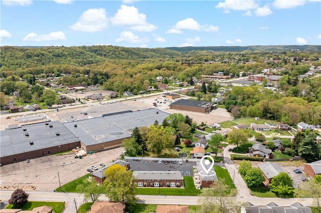 aerial view of residential area featuring a forest