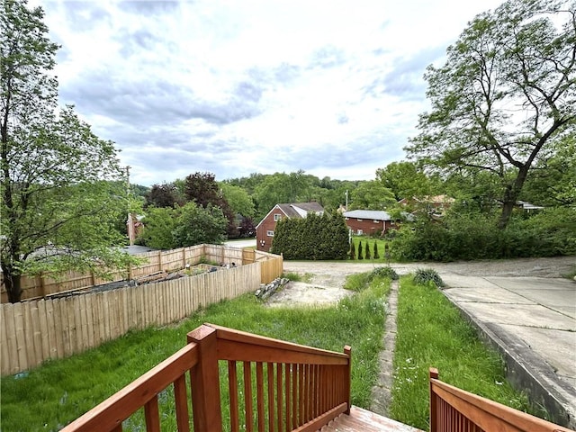 view of yard featuring fence and a deck