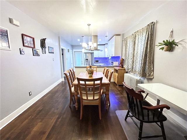 dining room featuring a chandelier, radiator, dark wood-style floors, and baseboards