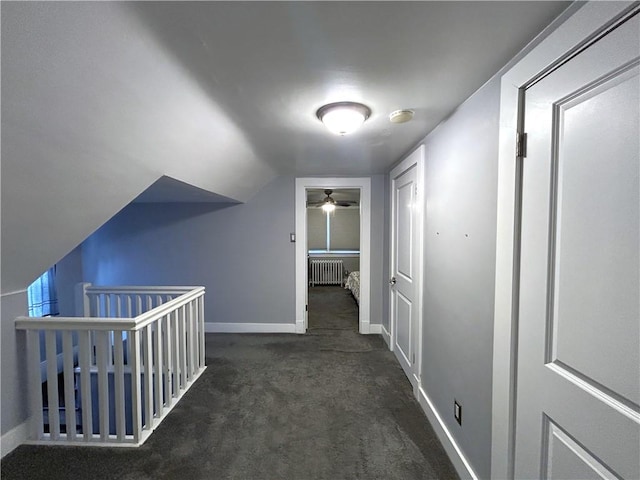 hallway with radiator, carpet floors, an upstairs landing, and baseboards