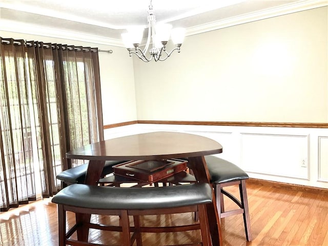 112 Pheasant Ridge Dr, Center Twp But, PA 16001 - dining space featuring a chandelier, light wood-style flooring, crown molding, and a wainscoted wall