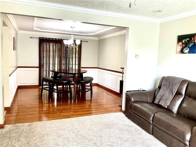 112 Pheasant Ridge Dr, Center Twp But, PA 16001 - dining room featuring a chandelier, wood finished floors, crown molding, a wainscoted wall, and a decorative wall