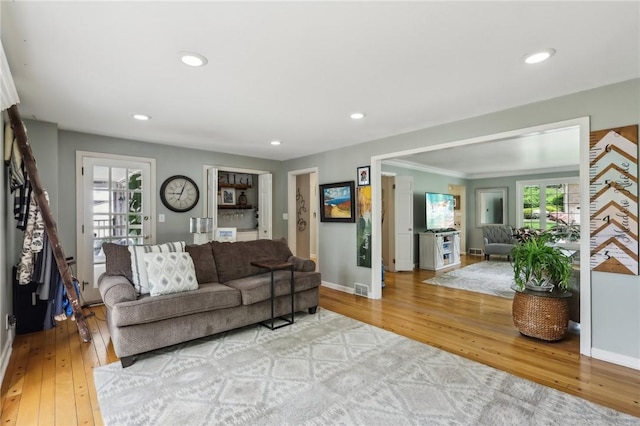 living room with wood-type flooring, stairway, baseboards, plenty of natural light, and recessed lighting