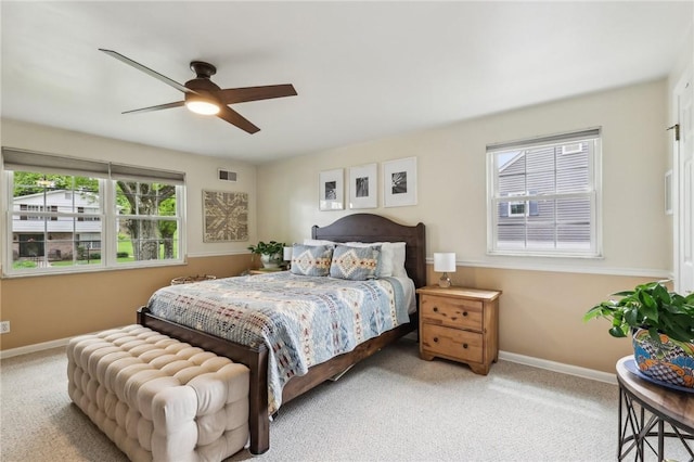 carpeted bedroom featuring baseboards and ceiling fan